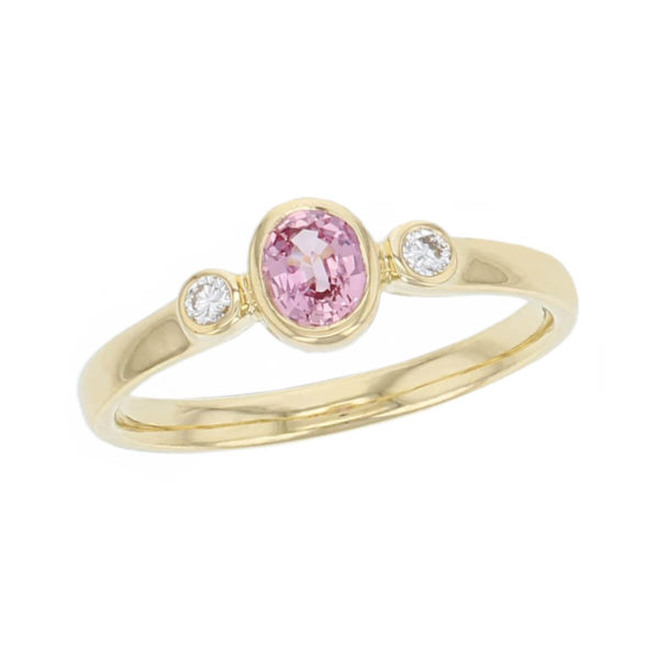 alternative engagement ring, 18ct yellow gold round brilliant cut diamond & oval cut pink peach sapphire trilogy ring designer three stone dress ring handmade by Faller, hand crafted, precious jewellery, jewelry, ladies , woman
